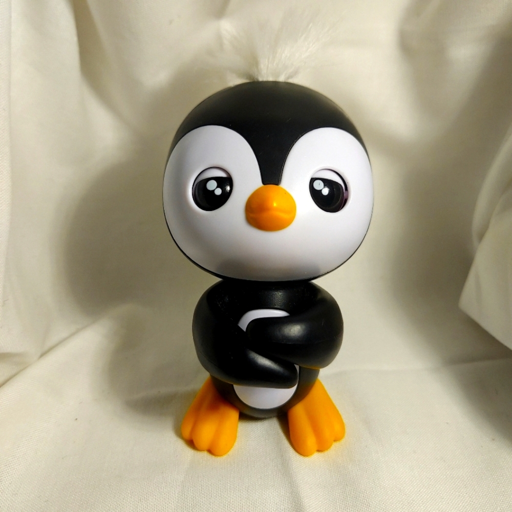 WowWee Fingerlings Baby Penguin Tux Talking and Light Up Finger Puppet